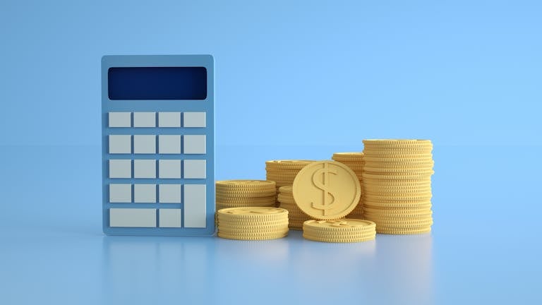 A conceptual image of a calculator with gold coins symbolizing finance and income growth.