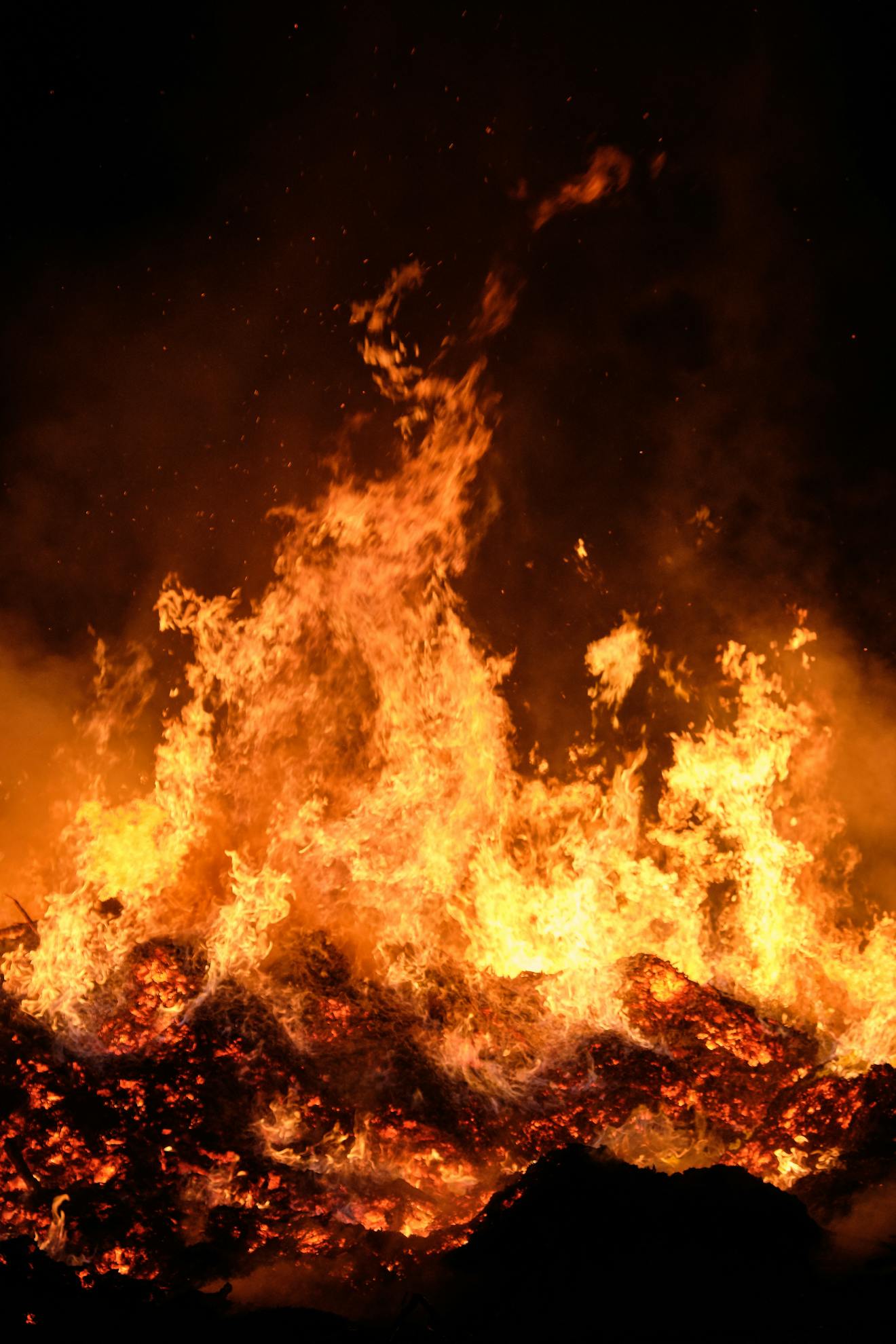Fiery blaze with intense heat and smoke creating a dramatic night scene.